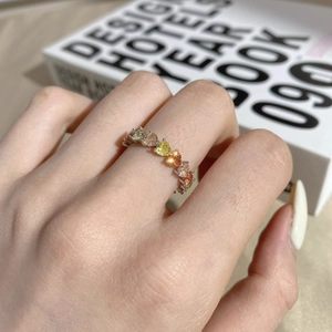 Detailed macro shot of multicolored heart-shaped crystals set on a silver eternity band