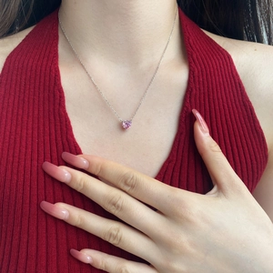 Close-up of a delicate S925 silver necklace featuring a heart-shaped pink zircon pendant