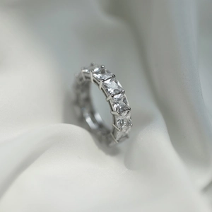 Macro view of S925 sterling silver eternity ring with square cut sparkling cubic zirconia