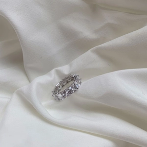 Macro shot of S925 sterling silver band with square-cut sparkling cubic zirconia stones
