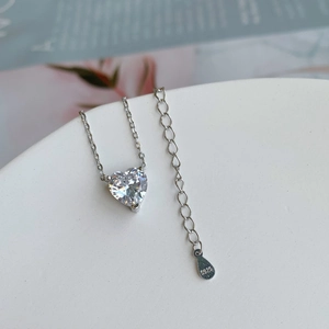 Detail of S925 sterling silver heart pendant with sparkling zircon and adjustable chain