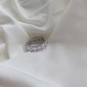 Macro detail of S925 sterling silver eternity ring with square-cut zircon stones