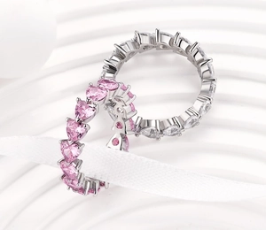 Close-up of S925 sterling silver eternity rings with pink and white heart-shaped crystals
