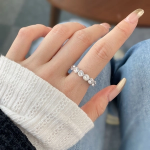 Elegant S925 sterling silver eternity ring with round zircon stones on a model's hand