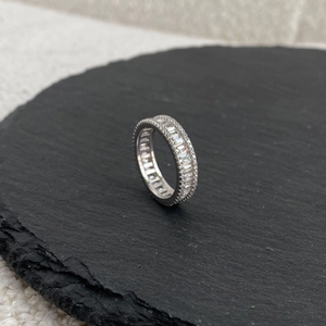 Macro detail of S925 sterling silver ring with baguette-cut and pavé cubic zirconia