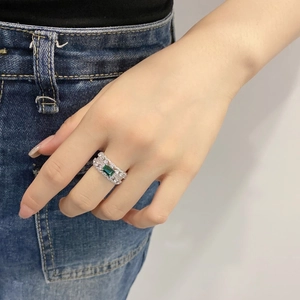 Detail of S925 sterling silver ring featuring a rectangular green emerald and pavé zircon