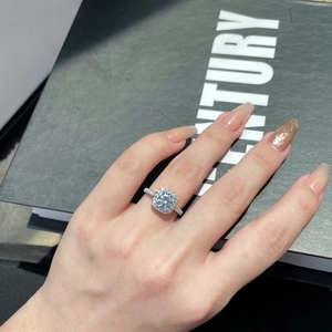 Macro shot of S925 silver cushion cut halo ring with pave setting on hand