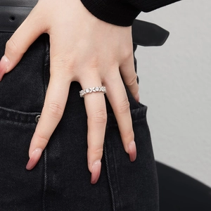 Macro detail of S925 silver ring featuring floral marquise zircon inlay on fingers