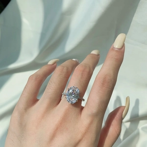 Detailed view of an oval-cut zircon engagement ring with a four-prong silver setting