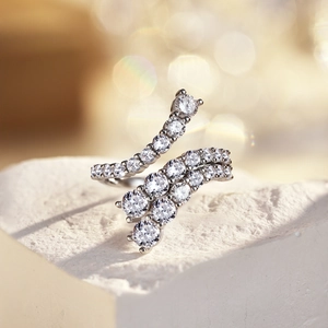 Close-up of S925 sterling silver ring with irregular zircon inlay on a stone base