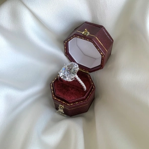 Close-up of a large oval-cut sparkling zircon ring in a luxury velvet gift box
