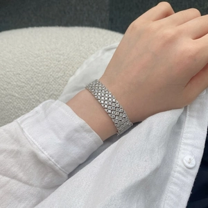 Macro view of a wide S925 sterling silver mesh tennis bracelet with full diamond pavé