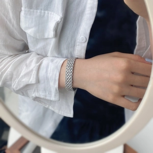 Close-up of sparkling multi-row mesh bracelet with silver-tone micro-pave crystals