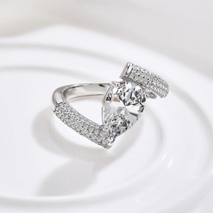Macro detail of pear-cut zircon and split-shank sterling silver ring on white texture