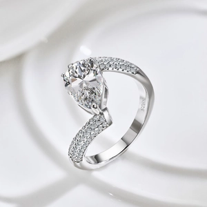 Elegant S925 sterling silver ring with a large pear-cut zircon and pavé diamond band