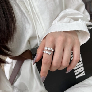 Detailed view of S925 silver wrap ring with shimmering cubic zirconia on model hand