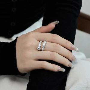 Detail of S925 sterling silver rings with symmetrical zircon inlay worn on model hand