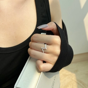 Macro detail of S925 sterling silver Z-shape ring with white enamel and marquise zircon