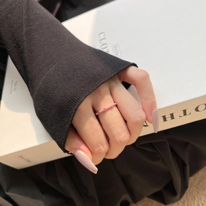 Elegant pink enamel S925 sterling silver ring with delicate cubic zirconia on a female hand