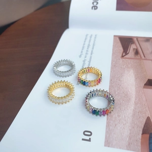 Macro detail of gold and silver eternity bands with baguette-cut rainbow stones