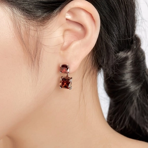 Close-up of S925 sterling silver studs with double square red zircon gemstones