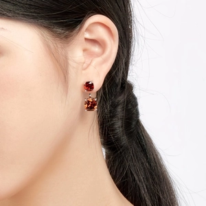 Detail of square-cut deep red zircon earrings in S925 silver square prong setting
