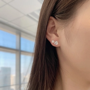 Close-up of S925 sterling silver heart-shaped stud earrings featuring sparkling zircon gems