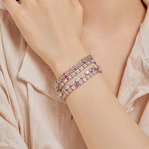 Close-up of S925 silver bracelets featuring colorful zircon stones on model's wrist
