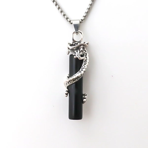 Polished black stone cylinder pendant with a silver carved dragon on a steel chain