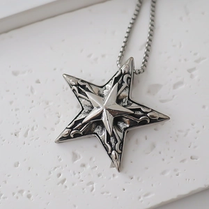 Detailed view of vintage star pendant with relief patterns on textured stone
