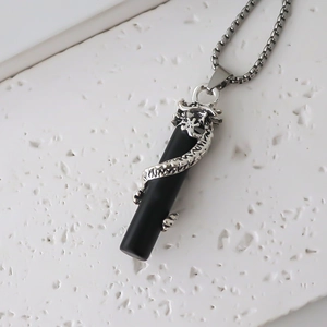 Close-up of a silver dragon wrapped around a black pillar pendant on a box chain