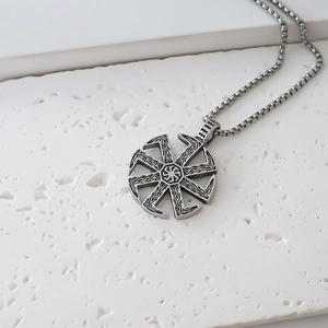 Macro shot of silver Kolovrat sun wheel pendant on a sturdy box chain necklace