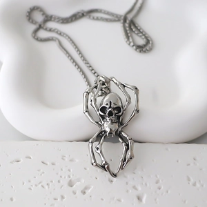 Detailed view of Gothic spider skull pendant with polished steel finish and curb chain