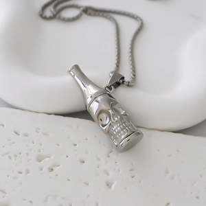 Detailed close-up of a silver punk skull bottle pendant on a fine metal chain necklace