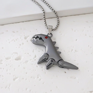 Detail of mechanical dinosaur pendant in gunmetal gray with a red star eye detail