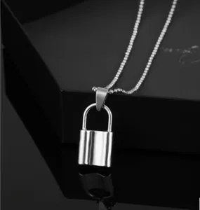 Detail of silver padlock pendant on ball chain with a polished metallic mirror reflection