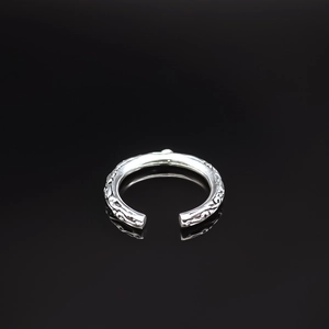 Detailed close-up of retro silver ring featuring intricate vintage vine carvings