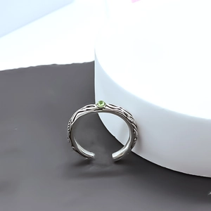 Silver open ring with vintage vine texture and a small green gemstone accent