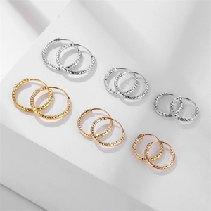 Titanium steel spiral hoop earrings with diamond-cut texture in gold and silver finish