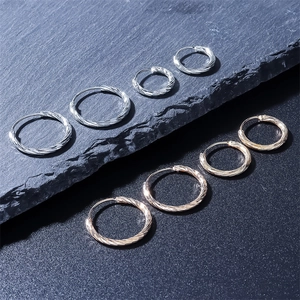 Minimalist spiral textured hoop earrings in silver and rose gold metal finishes
