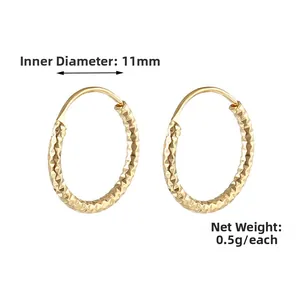 Detail showing 11mm inner diameter and 0.5g weight of golden faceted spring hoop earrings