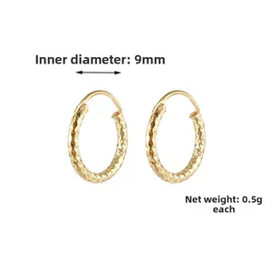 Detailed view of 9mm gold spiral earrings with diamond-cut texture and 0.5g weight