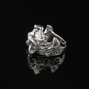 Macro shot of silver howling wolf ring detail with intricate fur texture and polished finish