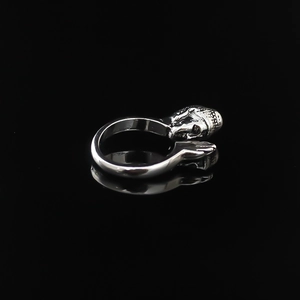 Detailed view of vintage silver Buddha head and folded hands on an open ethnic ring