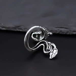 Detailed view of silver dragon ring with intricate scale textures and retro punk style