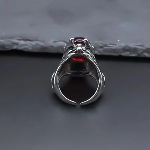 Detailed close-up of a vintage dragon head ring featuring a large red gemstone inlay