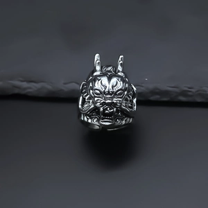 Detailed close-up of a vintage silver dragon head ring featuring intricate scales