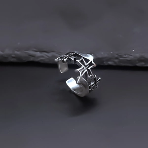 Macro shot of silver gothic cross ring with vintage finish and adjustable open band