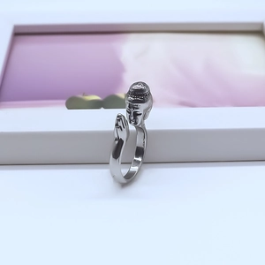 Close-up of silver-plated alloy Buddha ring with praying hands and adjustable band