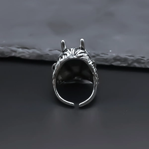 Retro dragon head adjustable open ring with gothic demon horns on a stone surface